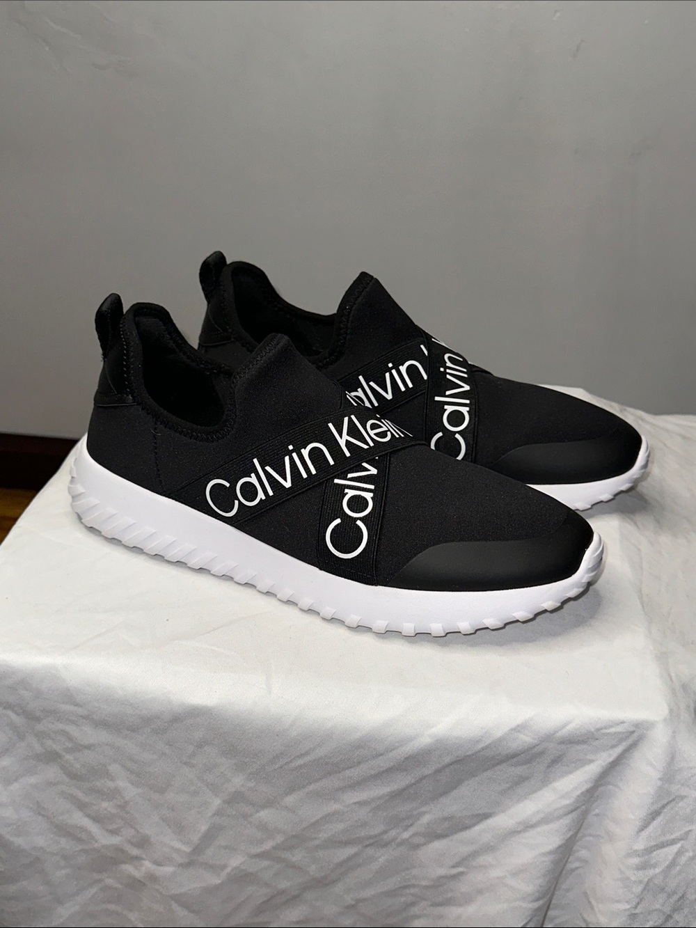 Calvin Klein Women’s Black and White Logo Slip-On Sneakers